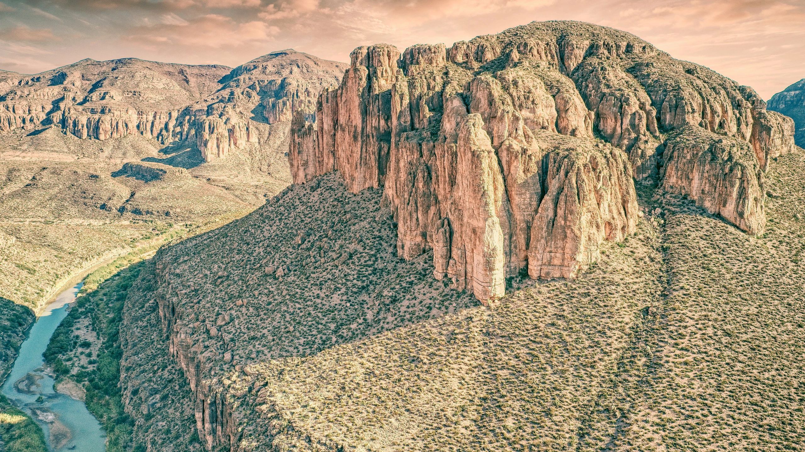 Aerial of a limestone mesa and cliff line with the river below